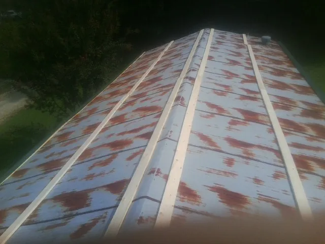 Rusted metal roof panels with new wood purlins before replacement — Storm Damage Roof Repair in Ash by Roofing Brothers